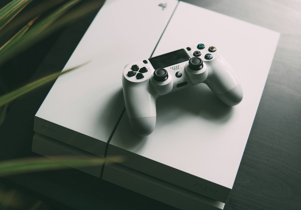 white playstation 4 console with controller